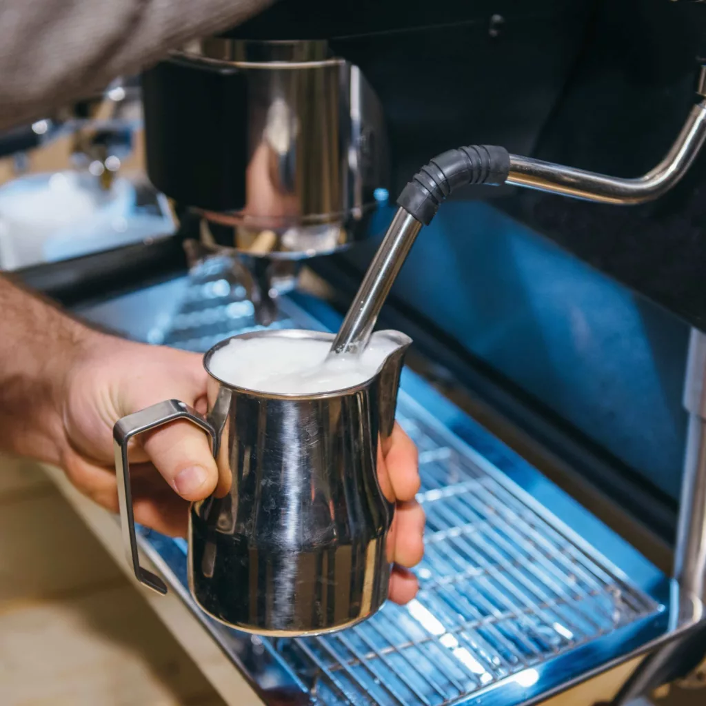 Frothing milk on an espresso machine.