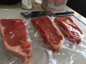 Three steaks vacuum packed in the VacMaster VP215 vacuum chamber