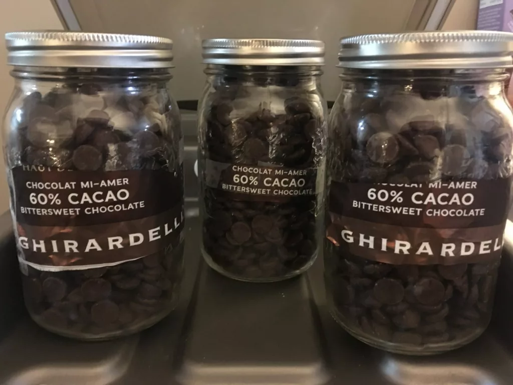 Chocolate chips preserved in vacuum packed mason jars using the VacMaster VP215 vacuum chamber.