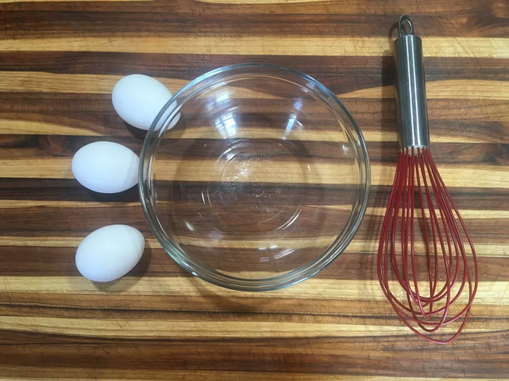 Preparing to scramble eggs with the Cuisipro 10-Inch Silicone Egg Whisk.
