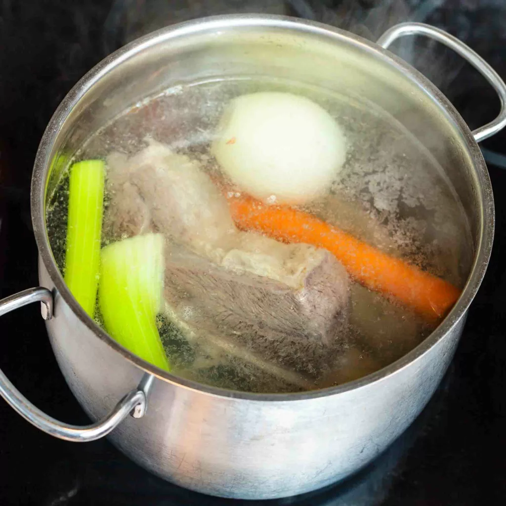 What exactly is a simmer? simmering beef broth in stockpot on ceramic cooker.