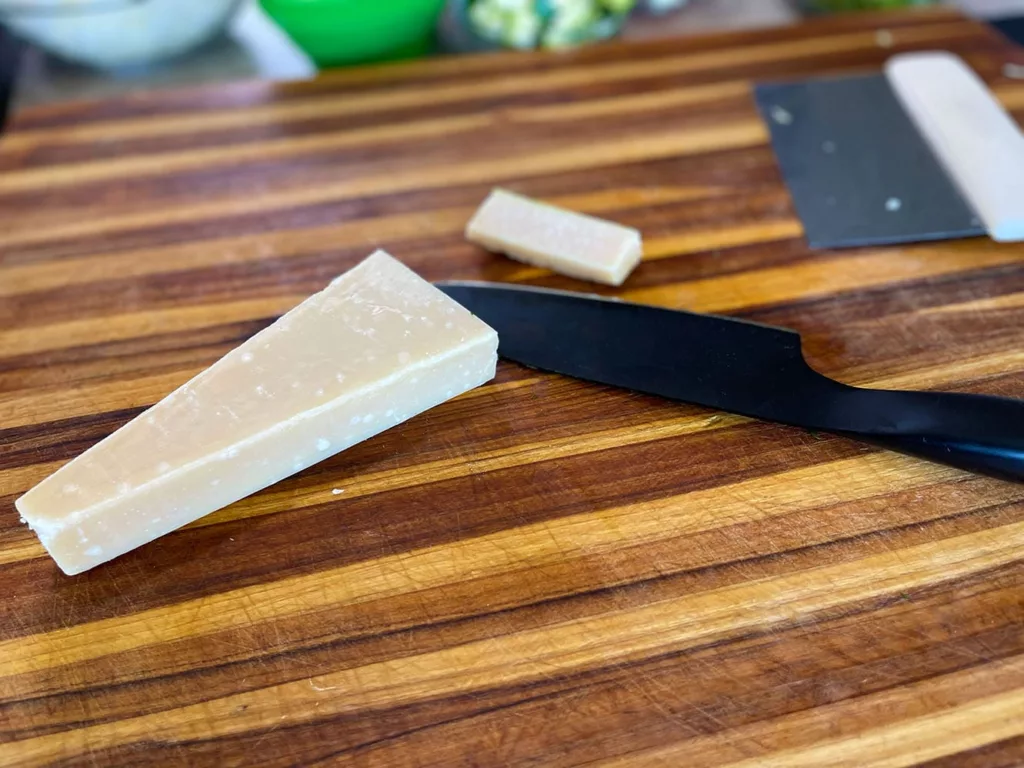 Cutting the rind from parmesan cheese using a Hast santoku knife.